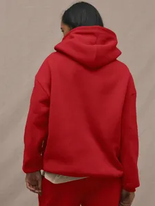 Rear view of red cotton hoodie set featuring a loose fit silhouette and dropped shoulders