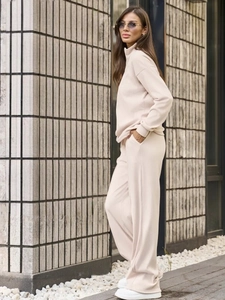 Women's chic lounge set featuring a high neck long sleeve top and wide leg knit trousers