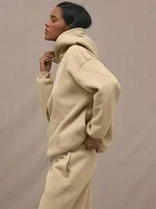 Detail of light beige hooded tracksuit featuring dropped shoulders and elastic cuffs