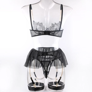 Detailed view of black lace lingerie set with gold chains and sheer mesh skirt detail