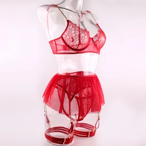 Detailed view of red lace lingerie set featuring gold chains and sheer mesh skirt detail