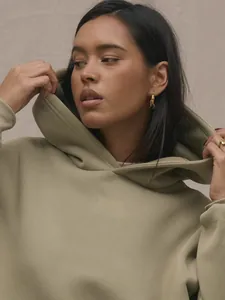 Detail view of high-quality light brown oversized hoodie with thick cotton fabric and drawstrings