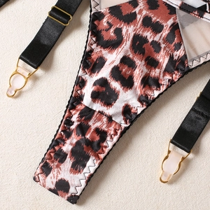 Detail of leopard print garter belt with sheer black mesh and gold-tone metal buckles