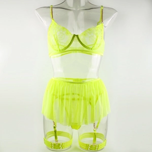Detail of neon yellow lace lingerie set with gold chain straps and adjustable leg garters