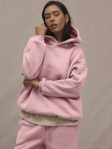 Close-up of pink oversized hoodie set showing thick knit fabric and layering detail