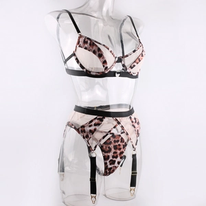 Close-up of leopard print mesh fabric with black elastic straps and metal buckles