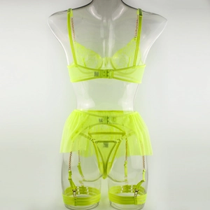 Detailed close-up of neon green lace lingerie with elegant gold metal chain straps