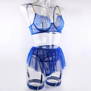 Detail of royal blue lace bra with gold chain straps and floral embroidery textures
