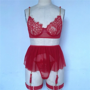 Detail of red lace lingerie set featuring golden chain straps and sheer mesh skirt