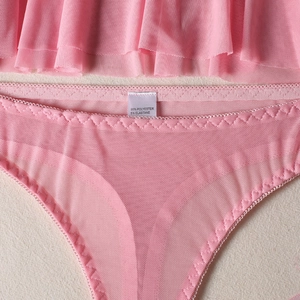 Detail of pink mesh panties with ruffle hem and wave-stitched edges in sheer fabric