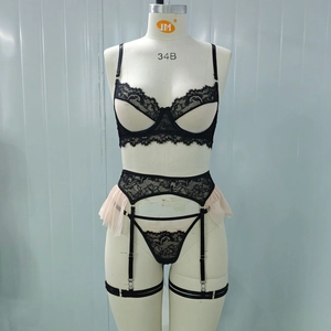 Front detail of black lace lingerie set with pink mesh trim and garter on mannequin