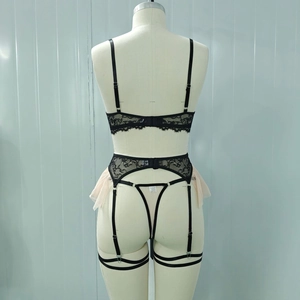 Rear view detail of black floral lace lingerie set with pink mesh ruffles on mannequin
