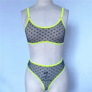 Detail of neon green trim on black polka dot mesh bra set with breathable fabric