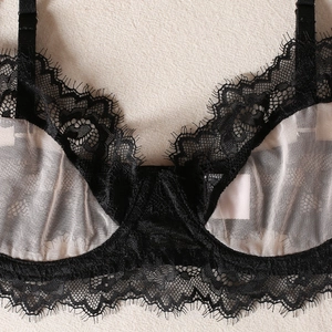Close-up of black eyelash lace and sheer mesh detail on underwired lingerie bra