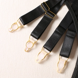 Detail of adjustable black garter straps with premium gold metal clips and buckles