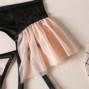 Detailed view of black lace stitching and light pink mesh fabric on sexy lingerie