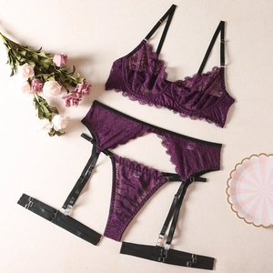Detailed flat lay of purple lace lingerie set with floral texture and garter belts