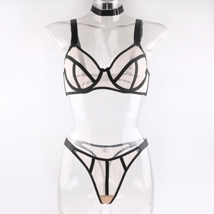 Detail of sheer beige mesh lingerie set with black geometric outlines on a mannequin