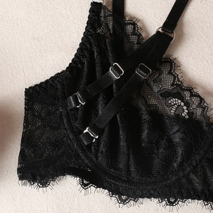 Detail of black eyelash lace lingerie with adjustable straps and silver metal rings