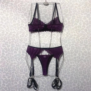 Detailed view of purple lace lingerie set with underwire bra and garter straps