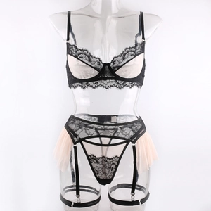 Detailed close-up of a three-piece black lace and pink mesh lingerie set with garter belt