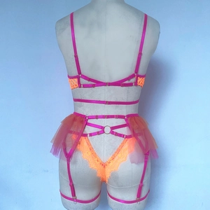 Detailed back view of neon orange lace lingerie set with mesh skirt and metal rings