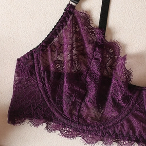 Close-up of violet eyelash lace fabric texture on underwire bra with black strap