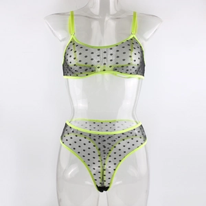 Detail of neon green trim on black polka dot mesh bra and thong lingerie set