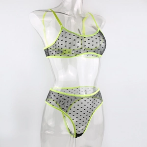 Detail of polka dot mesh lingerie set featuring neon green trim and high cut thong