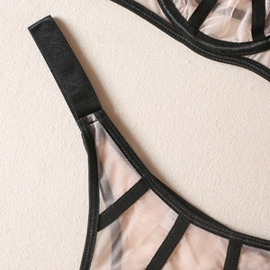 Detailed macro view of black elastic webbing and sheer mesh on a sexy lingerie set