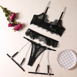 Close-up of black eyelash lace lingerie with decorative silver metal chains