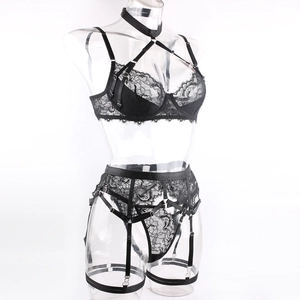 Detail of black lace lingerie set featuring eyelash lace trim and integrated garter straps