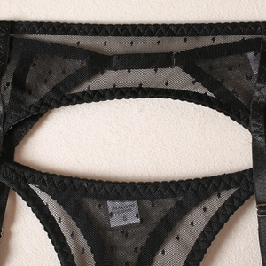 Detail of black polka dot sheer mesh lingerie set with scalloped lace edges and size S label