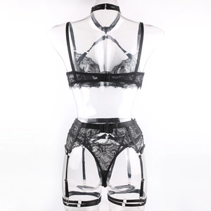 Detail of black floral lace lingerie set featuring strappy waist belt and back closure