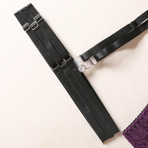 Close-up of adjustable black elastic straps with metal buckles and purple lace detail