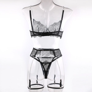 Detail of black lace lingerie set featuring sexy metal chains and garter belt straps