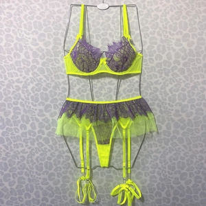 Detail of neon lace lingerie set featuring purple floral patterns and adjustable garter straps