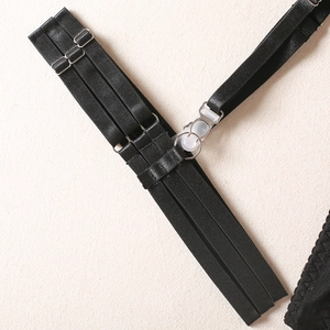 Detail of black elastic garter belt with silver metal buckles and three-row strap design