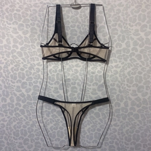Detail of sheer black and nude mesh lingerie set on silver wire frame display