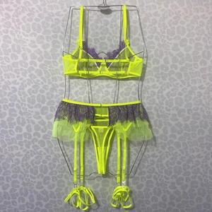 Detail of neon green mesh lingerie set with purple lace trim and garter belt