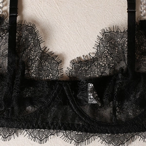 Macro shot of eyelash lace detail with delicate silver metal chains and mesh texture