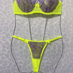 Close-up of fluorescent yellow lace bra with purple embroidery and bow detailing