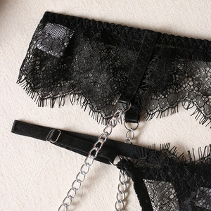 Detailed close-up of black eyelash lace lingerie featuring bold silver metal chains