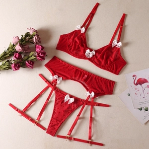Detailed view of red mesh lingerie set with heart patterns and white silk bows