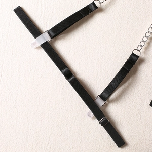 Detail of black elastic garter strap with adjustable silver buckle and secure grip clip