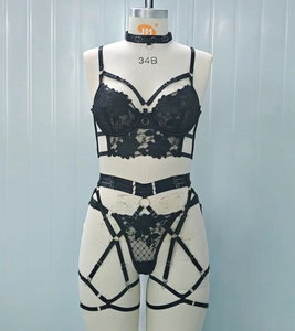 Detail of black lace lingerie set featuring intricate embroidery and multi-strap design