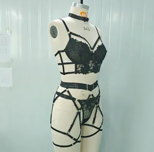 Detail of black embroidery lace bra with strappy harness design and underwire support