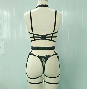 Rear view of black harness lingerie set with multi-strap cross design and metal ring details