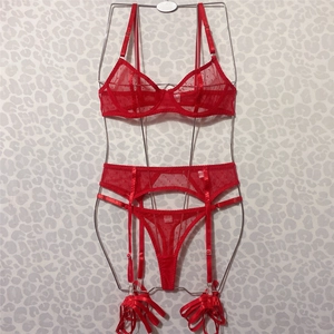 Detailed view of red polka dot mesh lingerie set including bra and garter belt