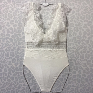 Detail of white eyelash lace stitching and ribbed knit fabric on a deep V bodysuit